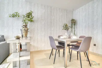 a dining room with a table and violet chairs at Surreal 1BR at The Residence Marina Gate 2 Dubai Marina by Deluxe Holiday Homes in Dubai