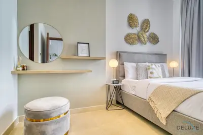 a bedroom with a bed with a mirror and a stool at Surreal 1BR at The Residence Marina Gate 2 Dubai Marina by Deluxe Holiday Homes in Dubai