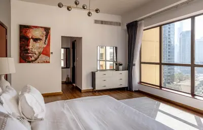 a bedroom with a bed and a large window at Luxury 1 bedroom with amazing full sea view! in Dubai