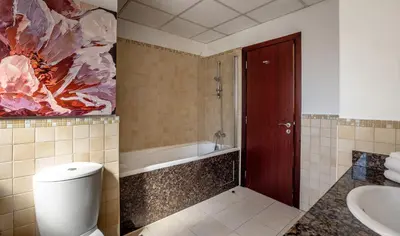 a bathroom with a toilet and a bath tub at Luxury 1 bedroom with amazing full sea view! in Dubai