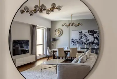a living room with a table and a mirror at Luxury 1 bedroom with amazing full sea view! in Dubai