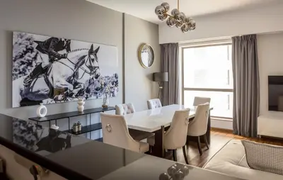 a dining room with a white table and chairs at Luxury 1 bedroom with amazing full sea view! in Dubai