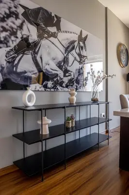 a living room with a horse painting on the wall at Luxury 1 bedroom with amazing full sea view! in Dubai