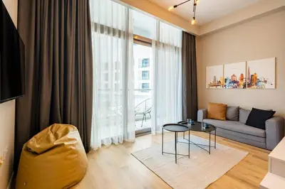 a living room with a couch and a table at Exclusive Designer Studio by Marina, Beach & Mall in Dubai