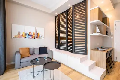 a living room with a couch and a table at Exclusive Designer Studio by Marina, Beach & Mall in Dubai