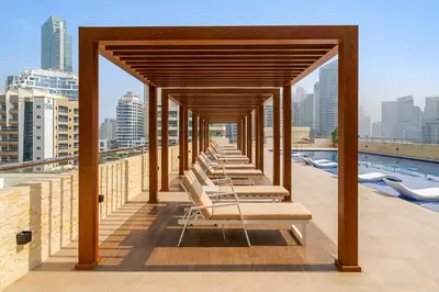 a row of lounge chairs on the roof of a building at Exclusive Designer Studio by Marina, Beach & Mall in Dubai