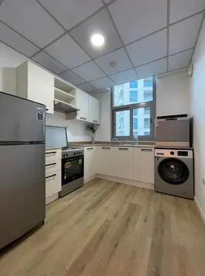 a large kitchen with a washer and dryer at Exclusive Designer Studio by Marina, Beach & Mall in Dubai