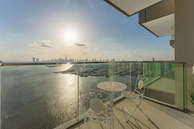 a balcony with a view of the water at Maison Privee - Trendy Apt on the Creek w/ Superb Dubai Skyline Vw in Dubai