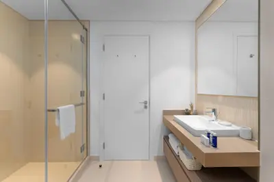 a bathroom with a sink and a shower at Maison Privee - Trendy Apt on the Creek w/ Superb Dubai Skyline Vw in Dubai