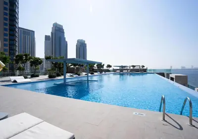 a large swimming pool on the roof of a building at Maison Privee - Trendy Apt on the Creek w/ Superb Dubai Skyline Vw in Dubai