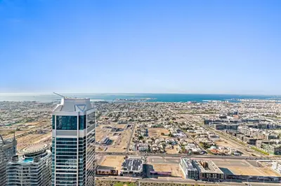 an aerial view of a city with a tall building at StoneTree - Paramount Tower Hotel&Residences 3 BR - Sea View and Infinity Pool in Dubai