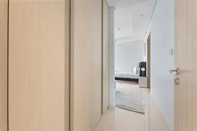 a hallway with a door leading to a bedroom at StoneTree - Paramount Tower Hotel & Residences 2 BR - Infinity Pool & Stunning View in Dubai