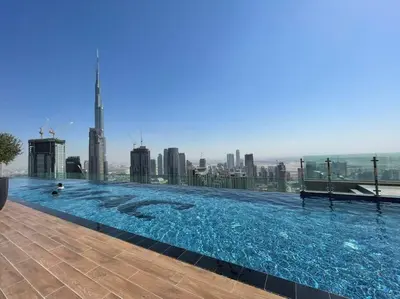 a large swimming pool on top of a building at StoneTree - Paramount Tower Hotel & Residences 2 BR - Infinity Pool & Stunning View in Dubai