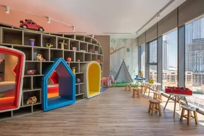 a childrens room with a play area with a play set at StoneTree - Paramount Tower Hotel & Residences 2 BR - Infinity Pool & Stunning View in Dubai