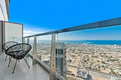 a balcony with a chair and a view of a city at StoneTree - Paramount Tower Hotel&Residences 2 BR - Amazing View in Dubai