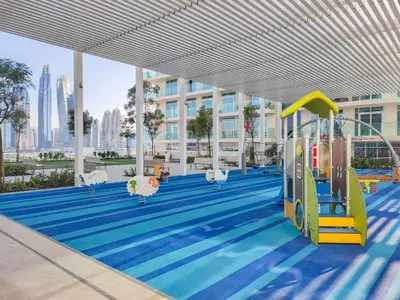 a swimming pool with a playground in a building at Maison Privee - Deluxe 3BR Apt with Dubai Marina Vws & Beach Access in Dubai