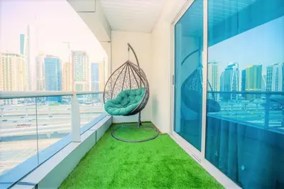 a room with a swing on a balcony at Royal Casa- Marina Diamond 2 in Dubai