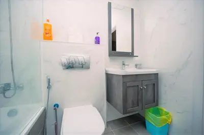 a bathroom with a toilet and a sink and a mirror at Royal Casa- Marina Diamond 2 in Dubai