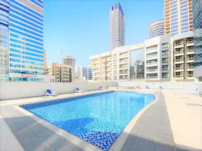 a large swimming pool in a city with tall buildings at Royal Casa- Marina Diamond 2 in Dubai