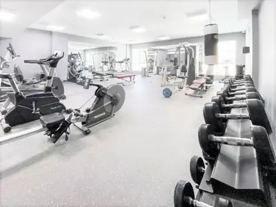 a gym with several treadmills and machines at Royal Casa- Marina Diamond 2 in Dubai