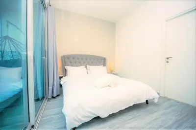 a bedroom with a white bed and a large mirror at Royal Casa- Marina Diamond 2 in Dubai