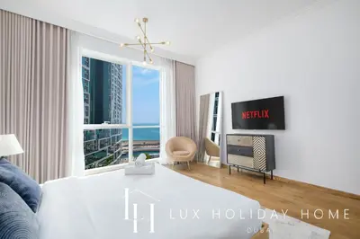 a living room with a view of the ocean at LUX The JBR Beach Sea View Suite in Dubai