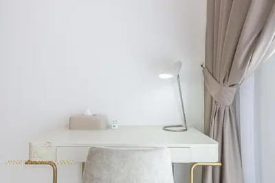 a white desk with a lamp and a chair at Marco Polo - Wake up to stunning sea views at Stella Maris in Dubai