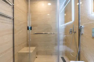 a shower with a glass door in a bathroom at Stylish and Central 1 BD in Downtown Dubai in Dubai