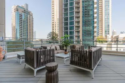 a balcony with chairs and a couch on a building at Stylish and Central 1 BD in Downtown Dubai in Dubai
