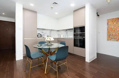 a kitchen and dining room with a table and chairs at Stylish and Central 1 BD in Downtown Dubai in Dubai