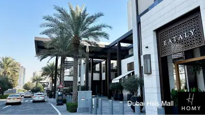 a street with palm trees in front of a building at Enjoy a Modern and Trendy apartment in the Heart of Dubai in Dubai