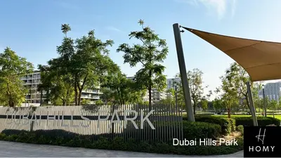 a fence in front of a building with an umbrella at Enjoy a Modern and Trendy apartment in the Heart of Dubai in Dubai