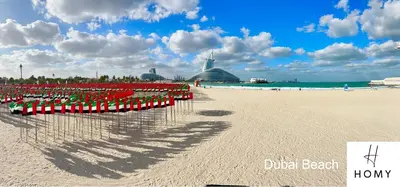 a beach with a bunch of red chairs on it at Enjoy a Modern and Trendy apartment in the Heart of Dubai in Dubai