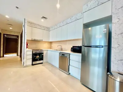 a large kitchen with a stainless steel refrigerator at Elegant & Chic 2bedroom balcony Creek Waterfront in Dubai