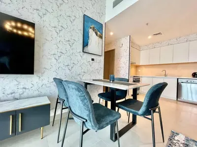 a kitchen with a table and chairs in a room at Elegant & Chic 2bedroom balcony Creek Waterfront in Dubai