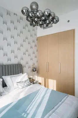 a bedroom with a bed and a chandelier at Modern & Chic 2bedroom with Balcony Dubai Creek in Dubai