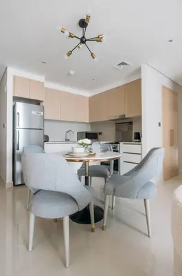 a kitchen with a table and chairs in a kitchen at Modern & Chic 2bedroom with Balcony Dubai Creek in Dubai
