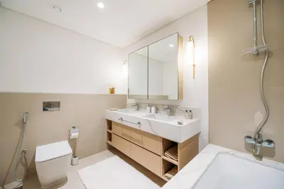 a bathroom with a sink and a toilet and a mirror at Modern & Chic 2bedroom with Balcony Dubai Creek in Dubai