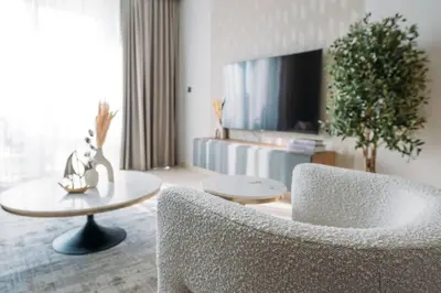 a living room with a chair and a table at Modern & Chic 2bedroom with Balcony Dubai Creek in Dubai