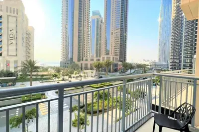 a balcony with a bench and a view of a city at Modern & Chic Waterfront 2bed balcony Dubai Creek in Dubai