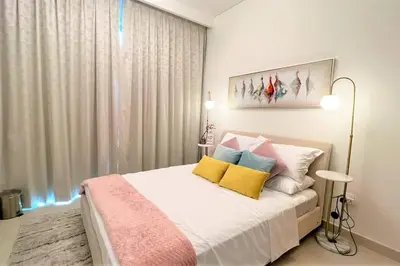 a bedroom with a bed with yellow and blue pillows at Modern & Chic Waterfront 2bed balcony Dubai Creek in Dubai