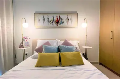 a bedroom with a bed with two lamps on it at Modern & Chic Waterfront 2bed balcony Dubai Creek in Dubai