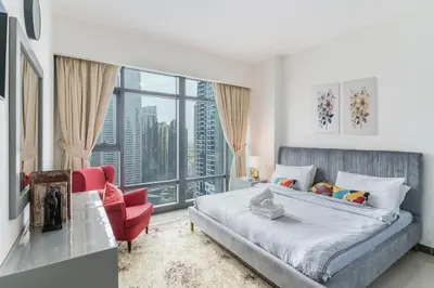 a bedroom with a bed and a large window at Scenic lake view 2BR near metro in Cluster A, JLT - Allsopp&Allsopp in Dubai