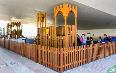 a wooden fence in front of a playground at Elegant Studio in Dubai Marina Near Beach and Metro Z1013 in Dubai