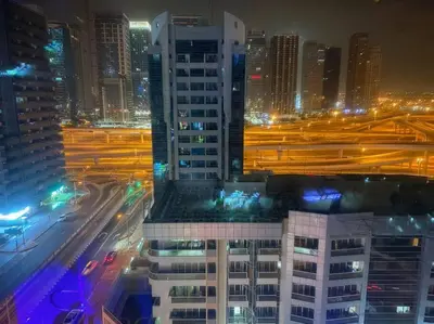 a view of a city at night with traffic at Elegant Studio in Dubai Marina Near Beach and Metro Z1013 in Dubai