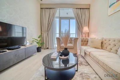 a living room with a couch and a tv at Peaceful 1BR in Studio One Dubai Marina by Deluxe Holiday Homes in Dubai