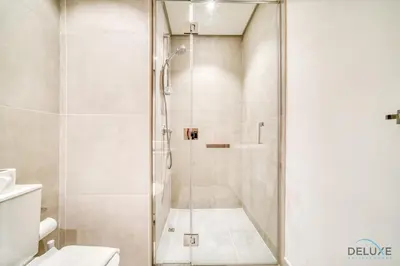 a shower with a glass door in a bathroom at Peaceful 1BR in Studio One Dubai Marina by Deluxe Holiday Homes in Dubai