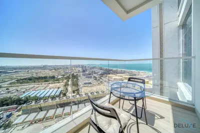 a balcony with a table and chairs and the ocean at Peaceful 1BR in Studio One Dubai Marina by Deluxe Holiday Homes in Dubai