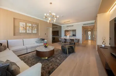 a living room with a couch and a table at EDEN'S Homes & Villas - Boulevard Point in Dubai