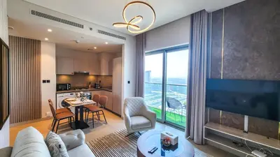 a living room with a couch and a dining room at STAY BY LATINEM Luxury 1BR Holiday Home CVR A2609 near Burj Khalifa in Dubai
